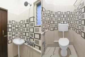 a bathroom with a toilet and a sink at Super Collection O Gariahat Kolkata Formerly 6 Seasons in Kolkata