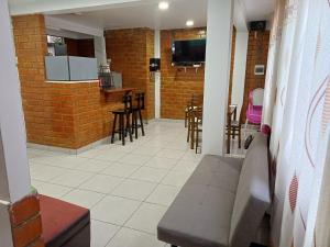a living room with a bar and some stools at Munay Wasy Carhuaz in Carhuaz