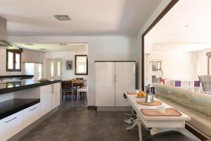 a kitchen and living room with white cabinets and a table at NorthStyle by Fidalsa in Lanestosa +29 photos
