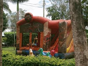 a person laying in front of a play house at Scenic View Hotel and Resort in Thika
