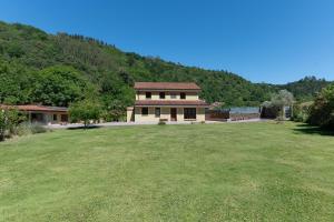 a house with a large yard in front of a mountain at NorthStyle by Fidalsa in Lanestosa
