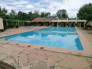 an empty swimming pool in front of a building at Scenic View Hotel and Resort in Thika