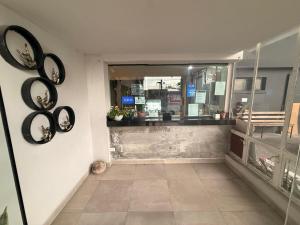 a store entrance with black plates on the wall at hotel 202 in Monterrey