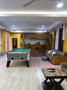 a living room with a pool table in it at Villa Char in Accra