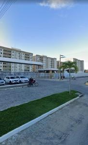 a person riding a motorcycle in a parking lot at Horto da Barra - Apartamento à Beira Mar in Barra dos Coqueiros