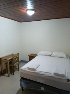 a bedroom with a bed and a wooden ceiling at Hostal Calle Real in León