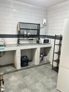 a kitchen with a counter with a microwave on it at Apartment Luxueux a Cité Apix in Niadyorane +6 photos