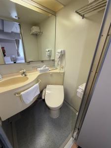 a bathroom with a toilet and a sink and a mirror at Hotel LEAP in Osaka +47 photos