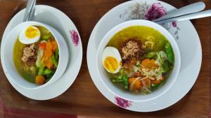 a bowl of soup with eggs on a table at Nan Bungalows Tetebatu in Tetebatu +44 photos