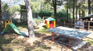 a playground with a table and a play set at Elba Residence in Capoliveri