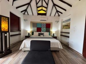 a bedroom with a large bed and a ceiling at CASA BOHEMIA - Resort de Cerveza y vino in Campoalegre +33 photos