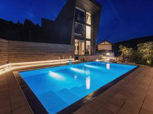 a swimming pool in front of a house at night at LANDFORM workshop cottage KEIHOKU in Kyoto