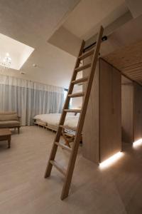 a bedroom with a ladder leading to a bed at ホテル寺町亘hotel teramachi watari in Matsue