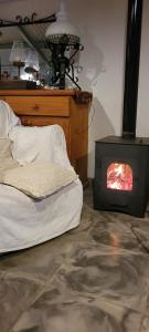 a bedroom with a fireplace with a bed and a stove at La Elvira in San Pedro +22 photos