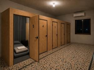 a room with a row of lockers and a bed at The Cozy Cube in Rawalpindi