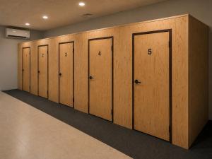 a row of wooden lockers in a room at The Cozy Cube in Rawalpindi