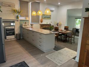 a kitchen with a counter and a dining room at Mimis Cottage in Cohuna