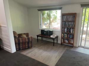 a living room with a couch and a table at Mimis Cottage in Cohuna