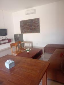 a living room with a couch and a table at villa tom and jerry in Senggigi