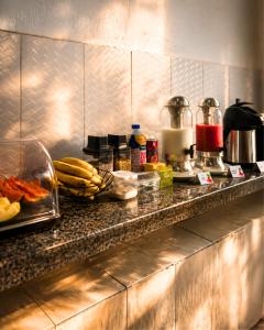 a counter in a kitchen with food on it at Caliani Hotel in Espigão dʼOeste +2 photos