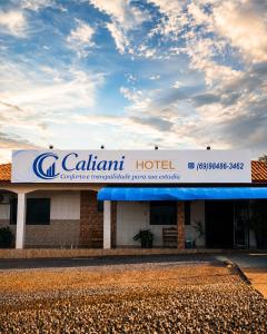a building with a sign for a caltrain hotel at Caliani Hotel in Espigão dʼOeste