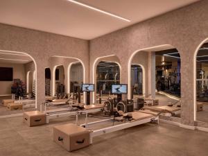 a gym with rows of mirrors and equipment in a room at Sofitel Sydney Wentworth in Sydney