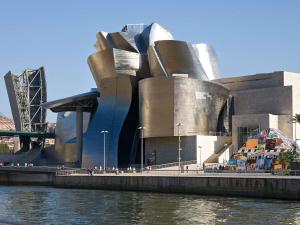 a building that is next to a body of water at Ibis Budget Bilbao Arrigorriaga in Arrigorriaga