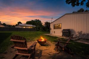 two chairs and a fire pit in a yard at Bancroft House on Scenic Mudgee Golf Course in Mudgee