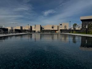 a large pool of water in front of a building at Un escape moderno dentro de Zibatá in San Vicente Ferrer