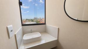 a bathroom with a white sink and a window at Made Hotel in São Luís