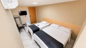 a hotel room with two beds and a television at Made Hotel in São Luís +12 photos