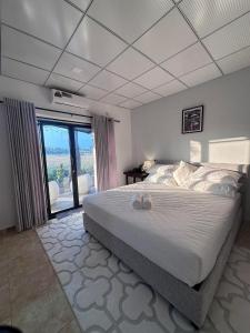 a bedroom with a large bed and a large window at Trump House in Anuradhapura