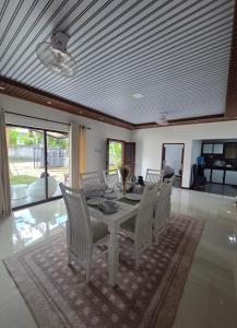 a dining room with a white table and chairs at Trump House in Anuradhapura