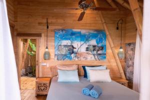 a bedroom with a bed in a wooden room at Villas Bukit Lipah in Amed