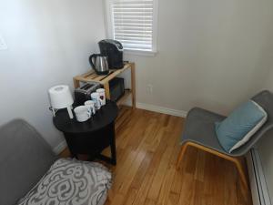 a living room with a table and two chairs at Sunny Ensuite Room with 2 Queen Beds-2A in Halifax