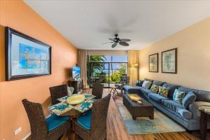 a living room with a couch and a table at Hale Mahina A102 in Kahana