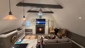 a living room with a couch and a fireplace at Granary Guest House in Goderich