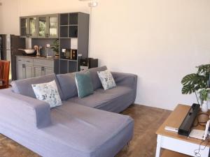a living room with a couch and a table at Villa Flora Bella Yellow Bell in Dauis