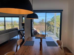 a living room with a table and a large window at Black Hill Retreat, Ballarat in Nerrina