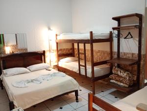 a room with two bunk beds and a mirror at Pousada Campo Alegre Eireli in Itatiaia +17 photos