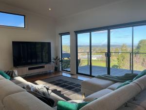 a living room with two couches and a flat screen tv at Black Hill Retreat, Ballarat in Nerrina