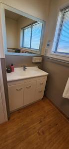 a bathroom with a sink and a mirror at Aalton Motel in Christchurch +35 photos