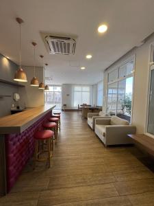 a living room with a bar and some chairs at Casa Luna in Americana