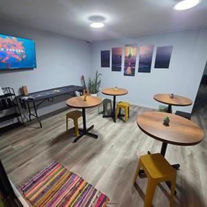 a room with tables and chairs and a piano at Lima Airport Hostel - FREE AIRPORT PICK UP in Lima