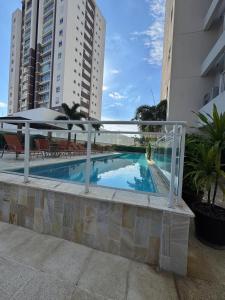 a swimming pool with an umbrella next to some buildings at Casa Luna in Americana