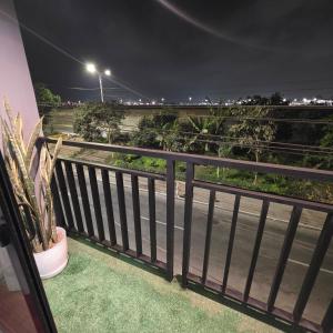 a balcony with a view of a street at night at Lima Airport Hostel - FREE AIRPORT PICK UP in Lima