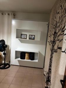 a white wall with three shelves in a room at Triplex no litoral in Matinhos