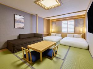 a room with two beds and a table and a couch at Rusutsu Resort Hotel & Convention in Rusutsu +82 photos