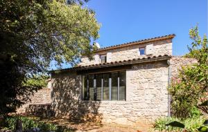 a stone building with a cat on top of it at Stones House in Labeaume