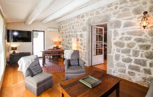 a living room with a stone wall at Stones House in Labeaume
